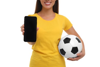Photo of Happy fan holding soccer ball and showing smartphone isolated on white, closeup