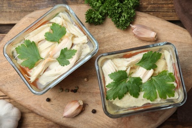 Photo of Delicious chicken aspic served on wooden board, top view