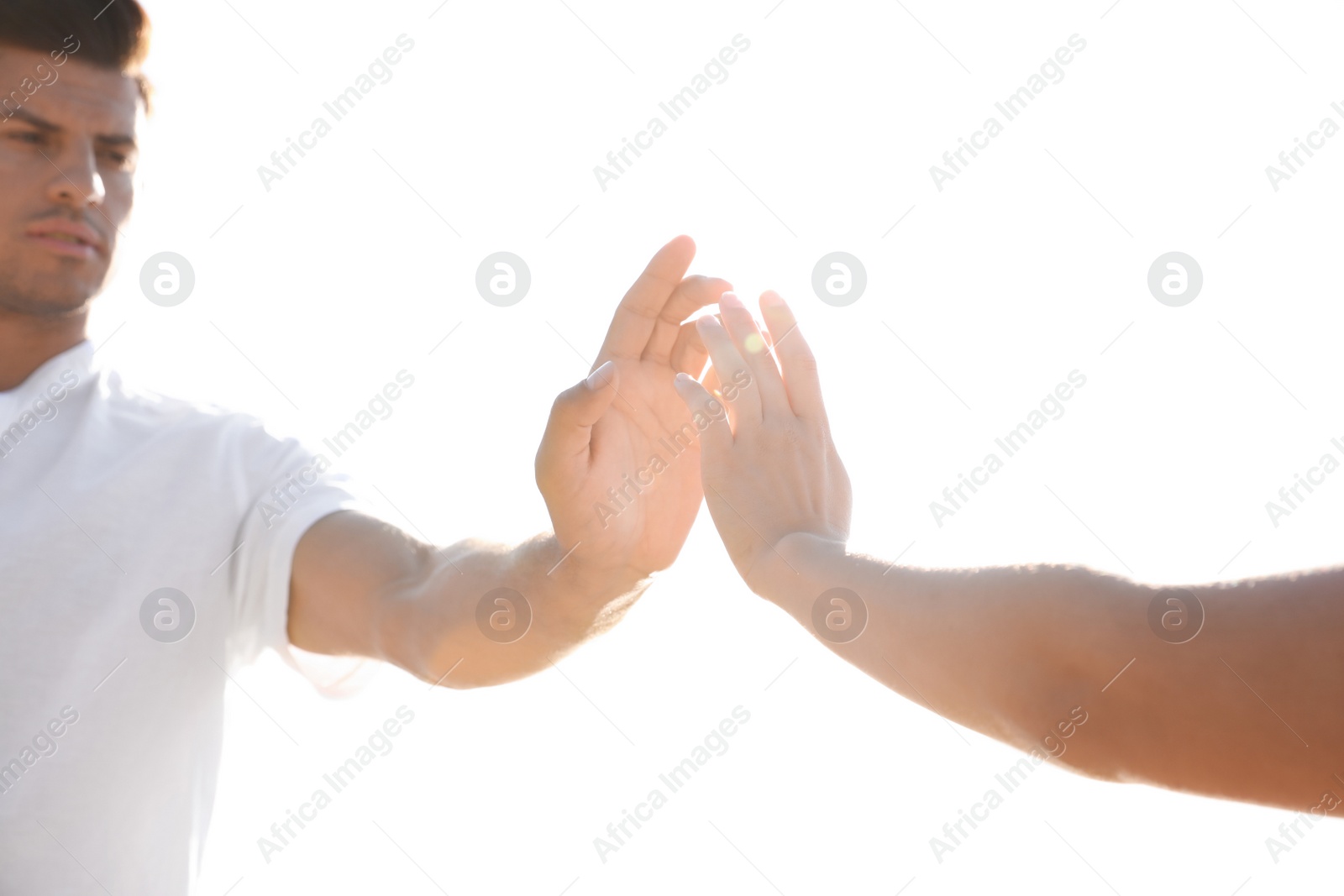 Photo of Man and woman reaching hands to each other near river. Nature healing power