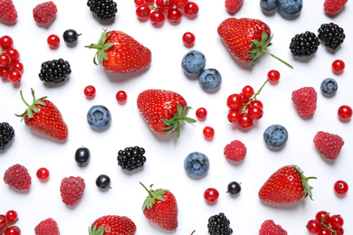 Mix of fresh berries on white background, flat lay