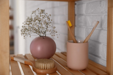 Photo of Shelving unit with toiletries indoors. Bathroom interior element