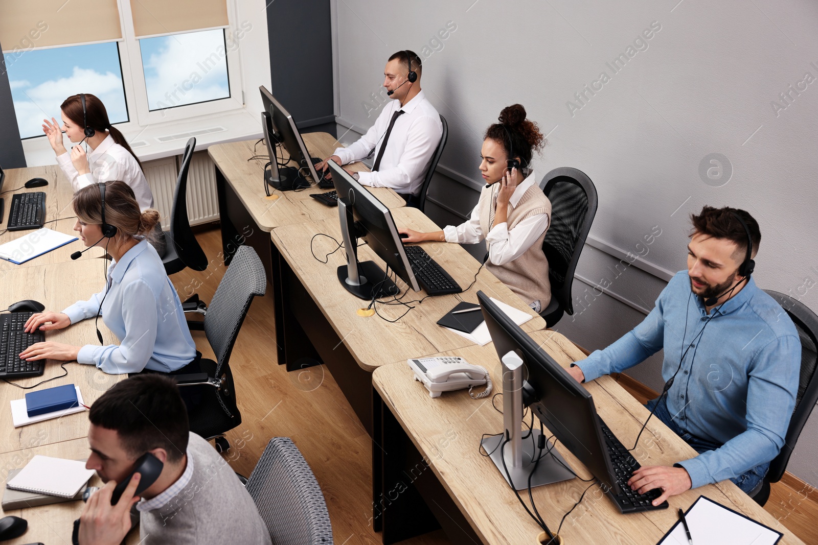 Photo of Call center operators working in modern office, above view