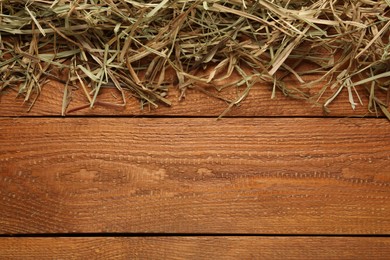 Photo of Dried hay on wooden background, flat lay. Space for text