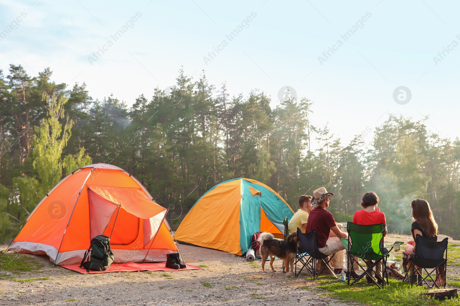 Photo of People resting near camping tent in wilderness