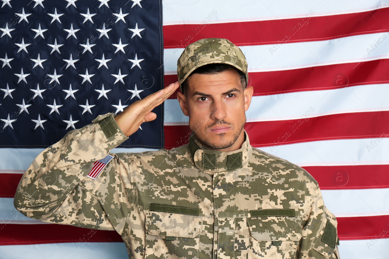 Photo of Soldier in uniform against United states of America flag