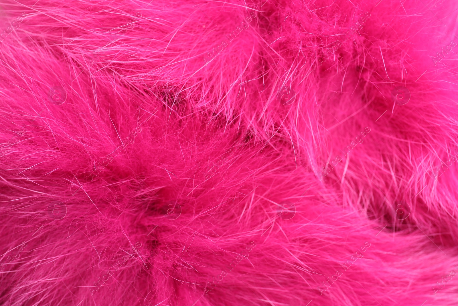 Photo of Texture of bright pink faux fur as background, closeup