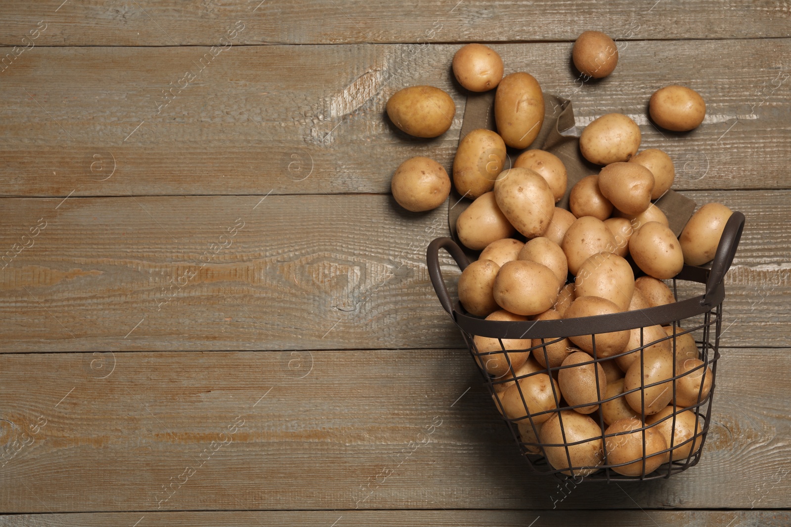 Photo of Raw fresh organic potatoes on wooden background, top view. Space for text