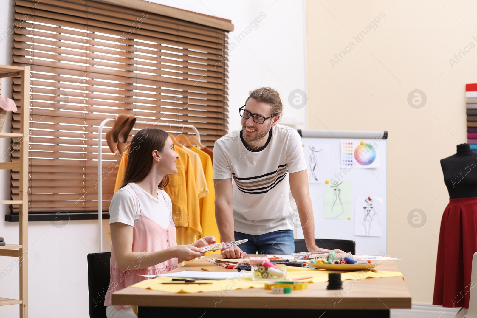 Photo of Fashion designers creating new clothes in studio