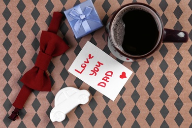 Photo of Composition with gift box and cup of coffee on color background. Father's day celebration