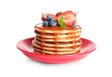 Plate of delicious pancakes with fresh berries and syrup on white background