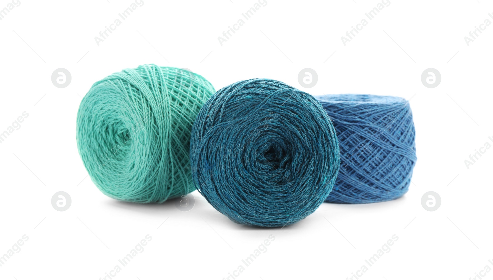 Photo of Clews of colorful knitting threads on white background