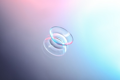 Contact lens on color glass background