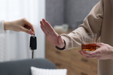 Drunk man refusing drive car while woman suggesting him keys, closeup. Don't drink and drive concept