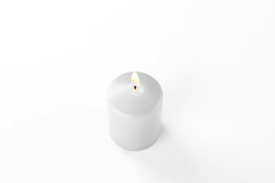 Photo of Burning grey wax candle isolated on white