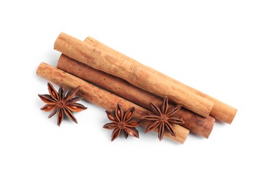 Aromatic cinnamon sticks and anise stars isolated on white, top view