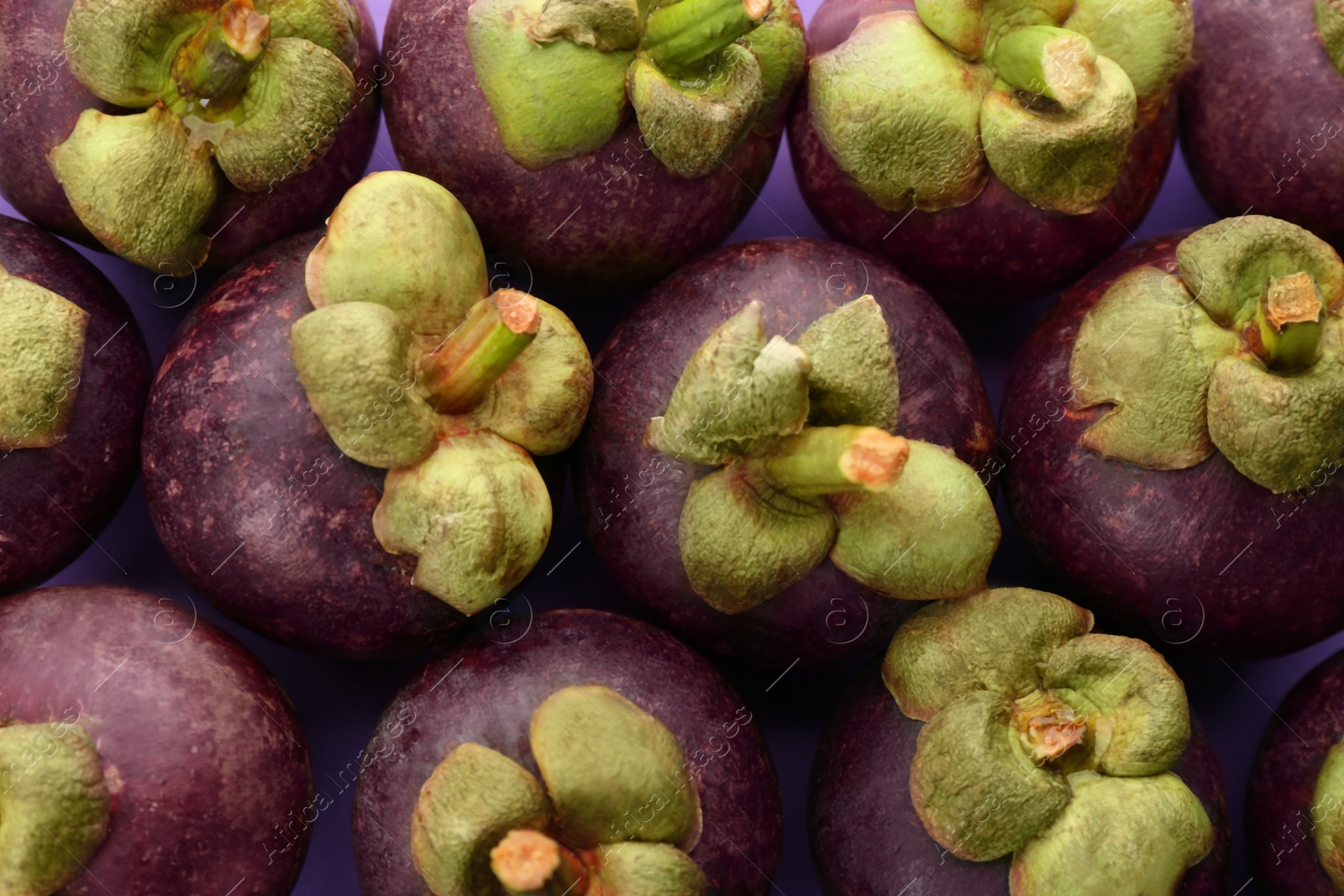 Photo of Delicious fresh mangosteens on color background, closeup