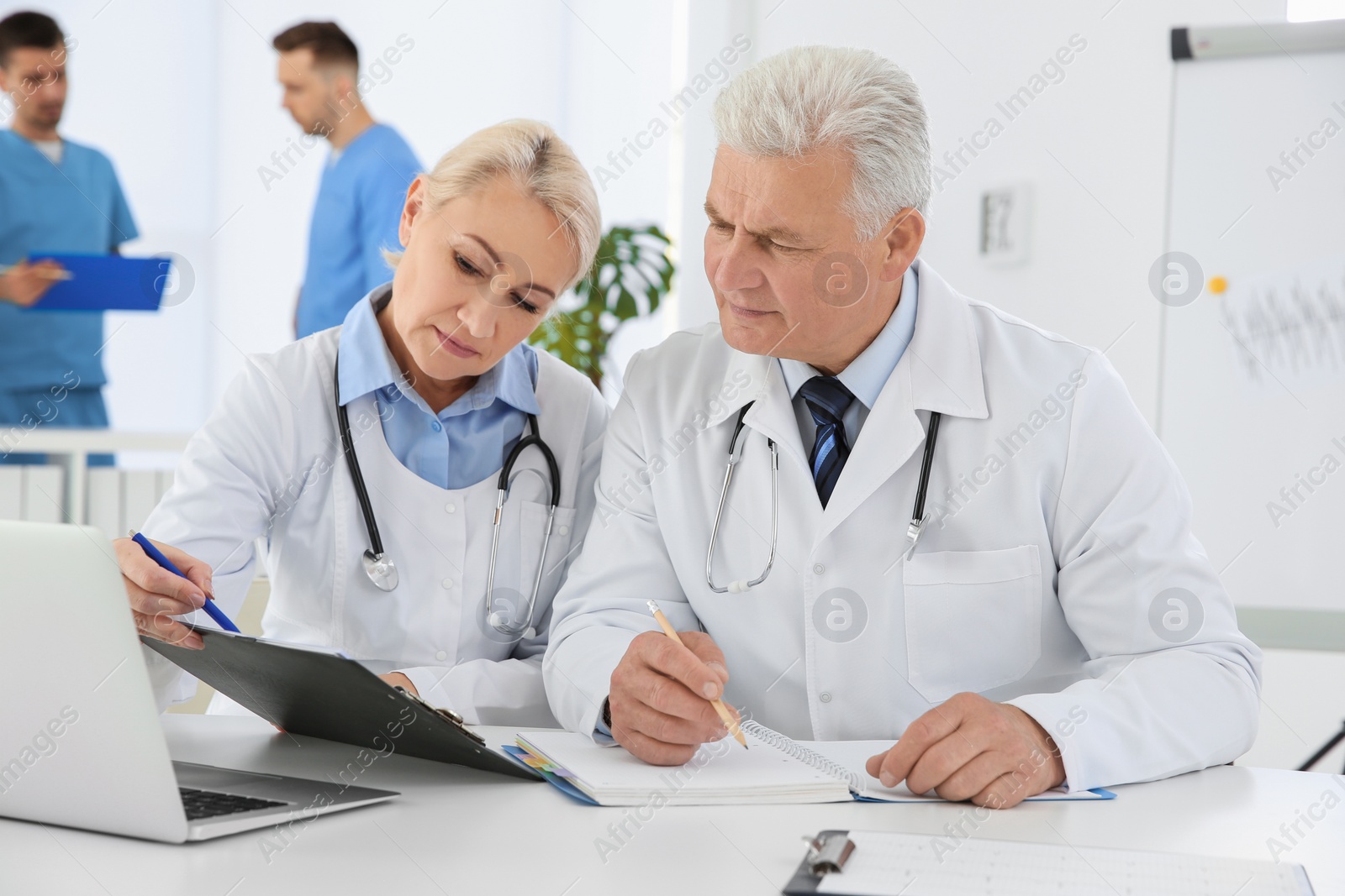 Photo of Group of doctors attending meeting in clinic. Cardiology conference