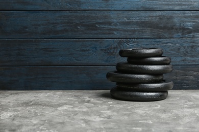 Photo of Composition of dumbbell plates on floor. Space for text