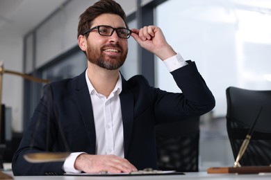 Smiling lawyer in office, low angle view