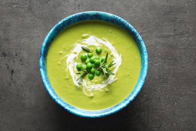 Fresh vegetable detox soup made of green peas in dish on table, top view