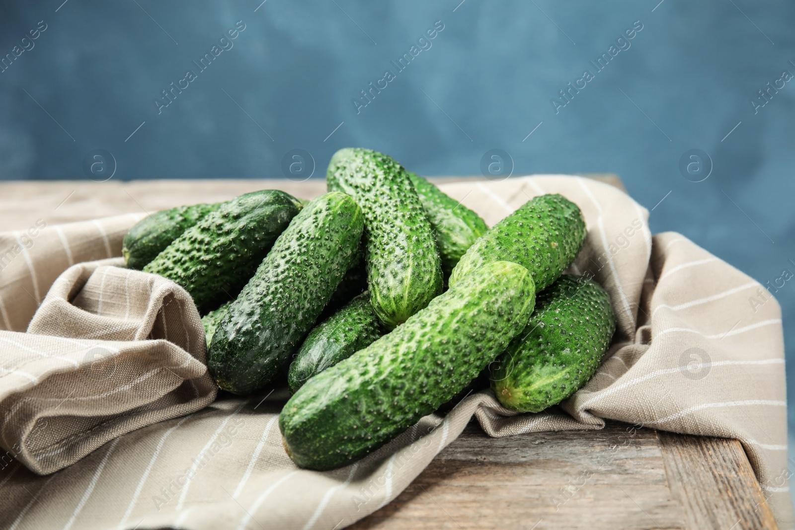 Photo of Ripe fresh cucumbers on wooden table