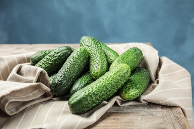 Photo of Ripe fresh cucumbers on wooden table