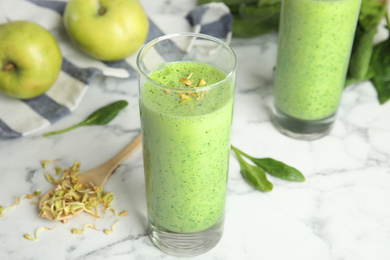 Green buckwheat smoothie on white marble table