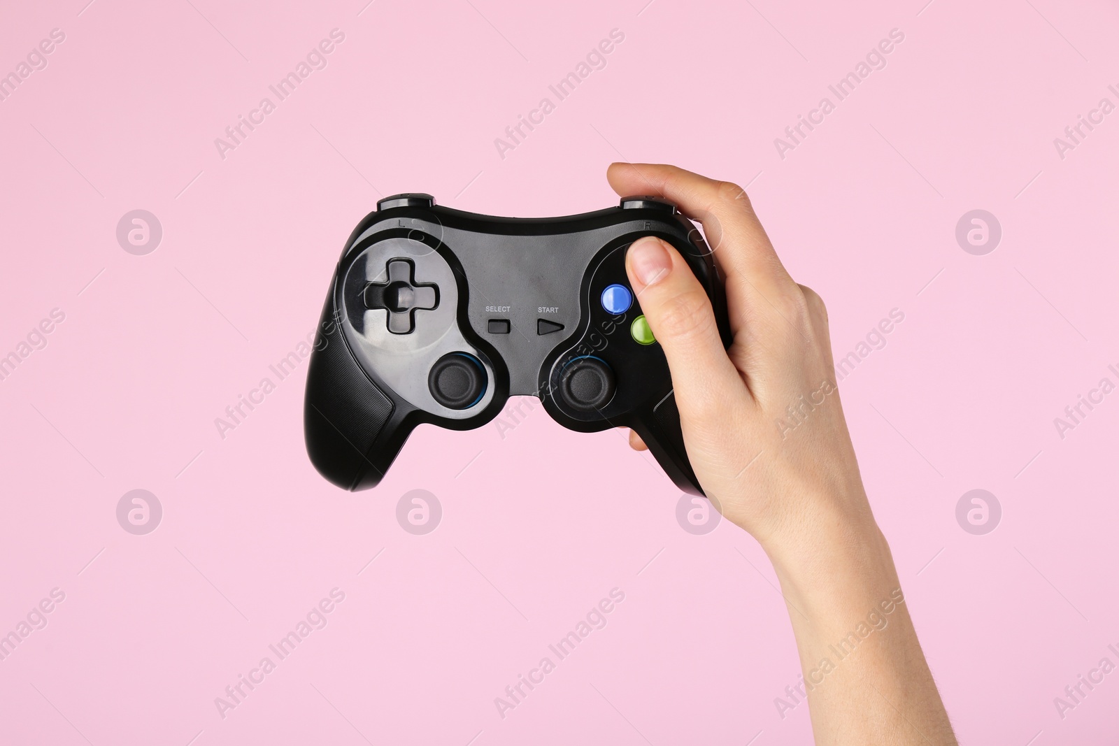 Photo of Woman with game controller on pink background, closeup