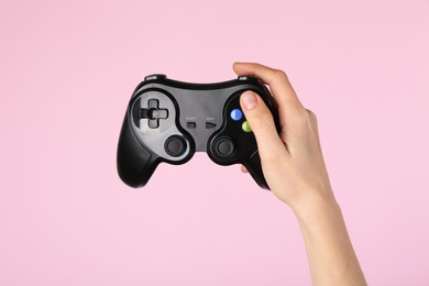 Photo of Woman with game controller on pink background, closeup