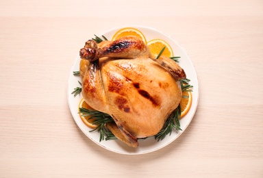 Delicious cooked turkey served on wooden table, top view. Thanksgiving Day celebration