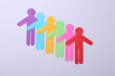 Equality concept. Paper human figures on light background, top view