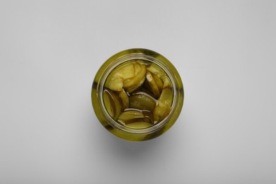 Jar of tasty pickled cucumbers on white background, top view