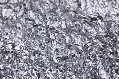 Crumpled silver foil as background, closeup view