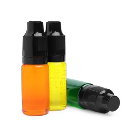 Bottles with different food coloring on white background