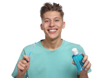 Photo of Young man with mouthwash and toothbrush on white background