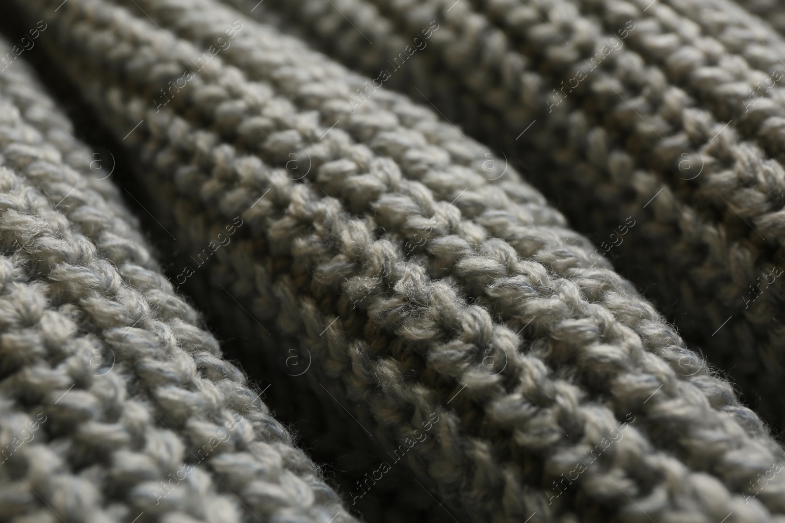 Photo of Beautiful grey knitted fabric as background, closeup