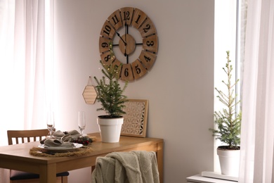 Small potted fir trees in dining room. Interior design