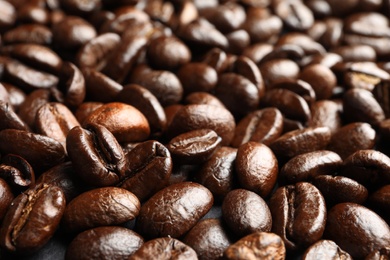 Pile of roasted coffee beans as background, closeup