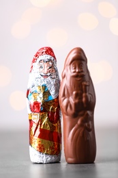 Photo of Chocolate Santa Claus candies on light background