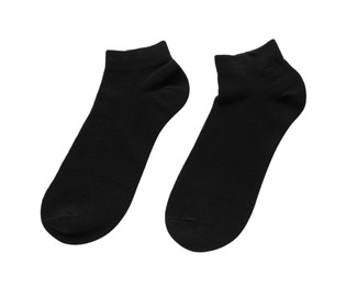 Photo of Pair of black socks on white background, top view