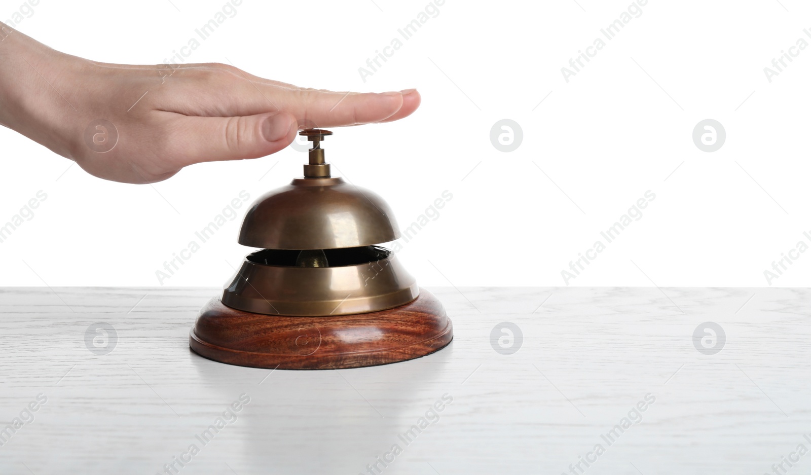 Photo of Woman ringing hotel service bell on white background