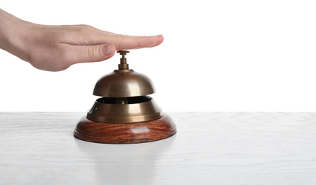 Photo of Woman ringing hotel service bell on white background