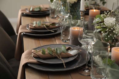 Photo of Festive table setting with beautiful floral decor indoors