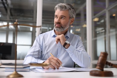 Photo of Portrait of handsome lawyer at table in office