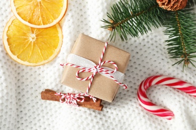 Flat lay composition with Christmas gift box on white crocheted background