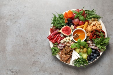 Photo of Set of different delicious appetizers served on light grey table, top view. Space for text