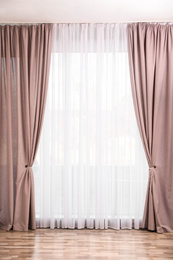 Photo of Window with elegant curtains in empty room