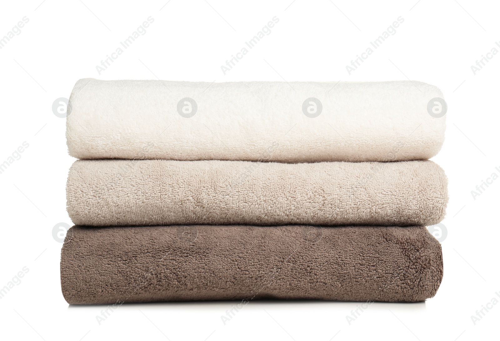 Photo of Folded soft terry towels on white background