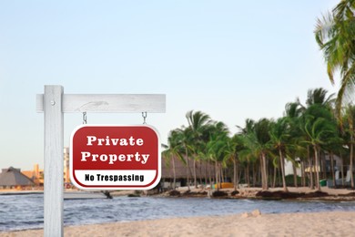 Sign with text Private Property No Trespassing on beach