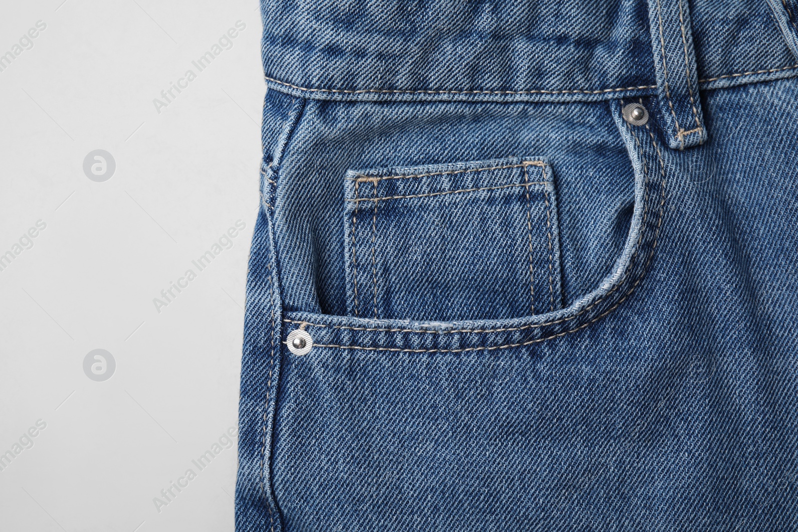 Photo of Jeans with pocket on light grey background, top view